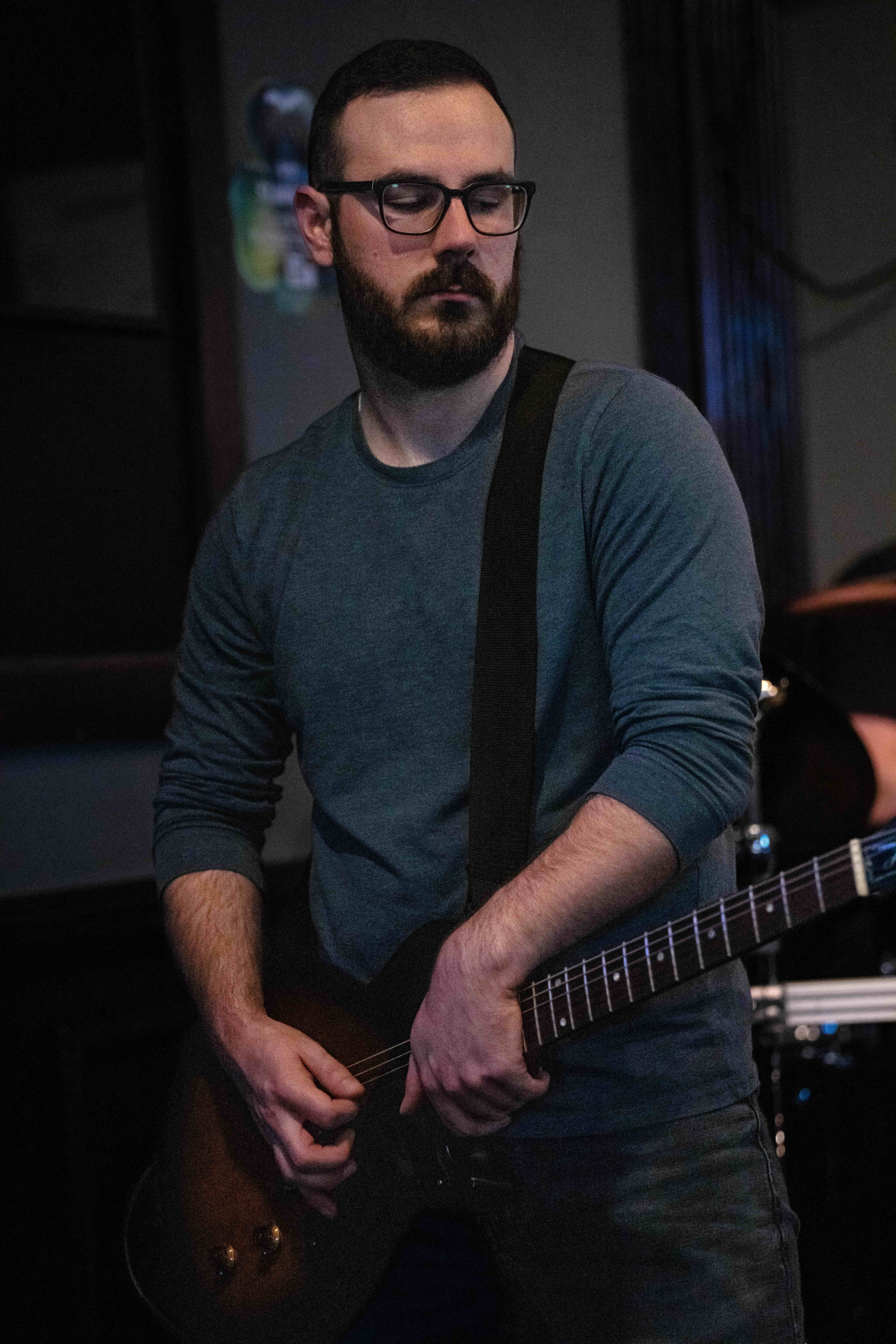 Zack, the guitarist of Party Fowl, performs in Plymouth, Michigan